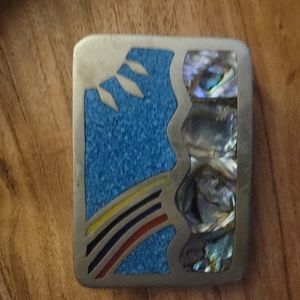 This sterling silver belt buckle has turquoise abalone in it.  Marked Mexico.